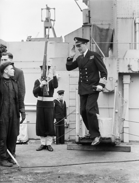 Frederic Walker saluting while he disembarks from a ship