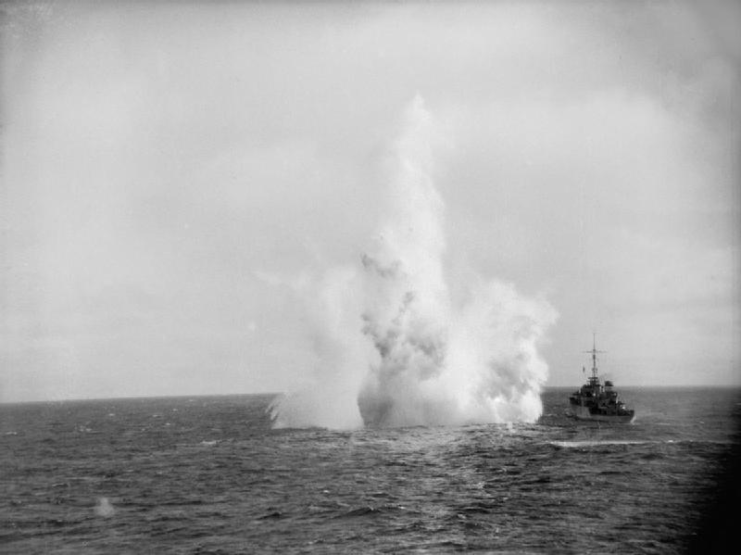 HMS Kite (U87) sailing past a depth charge explosion