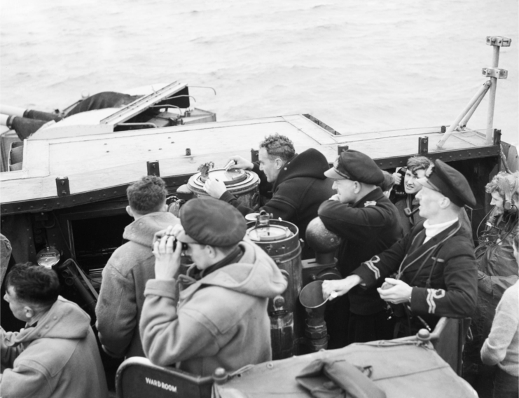 Crew of the HMS Starling (U66) standing on the ship's bridge