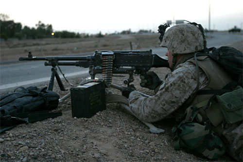 US Marine with Weapons Platoon, E Company, 2nd Battalion, 1st Marine Regiment, 1st Marine Regiment aiming an M240G machine gun