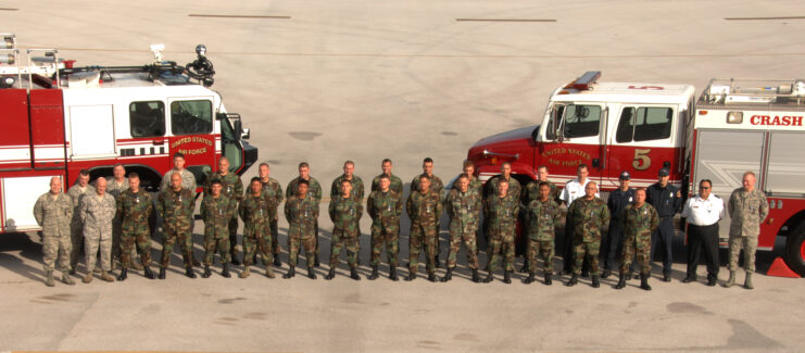 First responders standing in front of two fire trucks