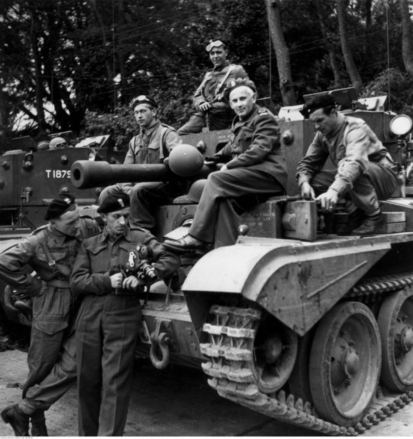 Members of the Polish 1st Armoured Division sitting atop a tank