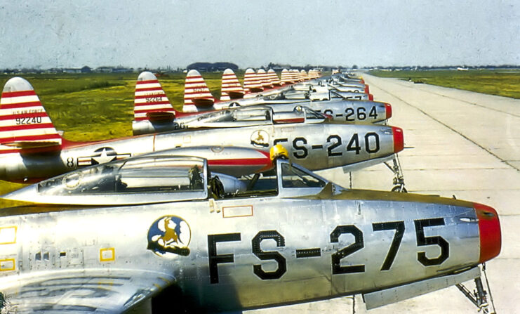 Row of Republic F-84E Thunderjets parked along a runway