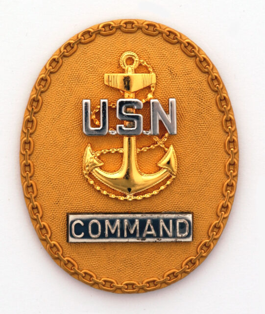 Command master chief petty officer emblem against a grey backdrop