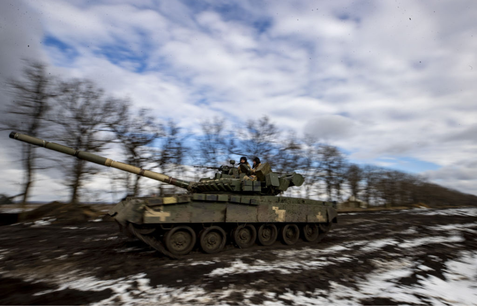 Ukrainian tank driving through the snow and mud