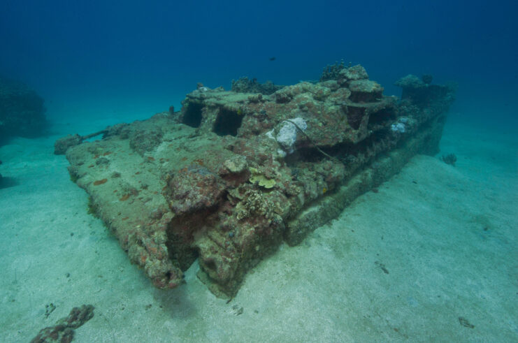 Rusty military vehicle resting on the seafloor