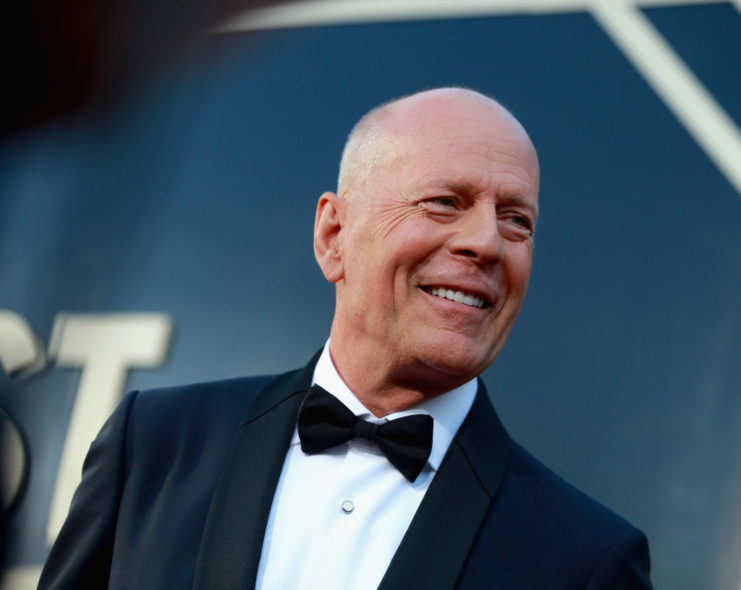 Bruce Willis posing on a red carpet
