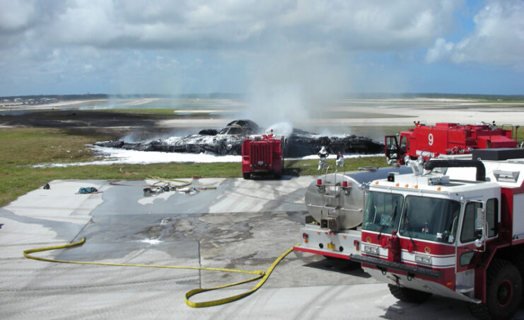 Firetrucks parked near the charred remains of the Northrop Grumman B-2 Spirit 'Spirit of Kansas'