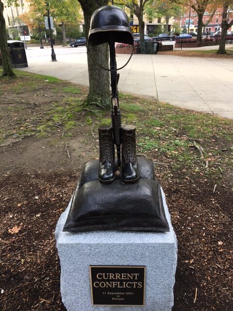 Bronze statue of a Battle Cross in the middle of an urban park