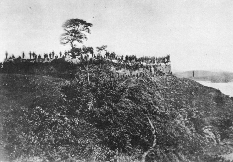 Soldiers standing atop a hill