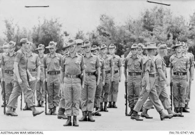 Creighton Abrams and J.A. Clark walking in front of soldiers standing at attention