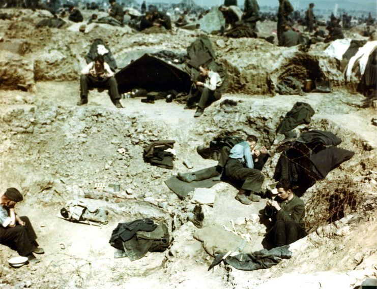 German prisoners of war (POWs) sitting in craters at the Sinzig prison camp