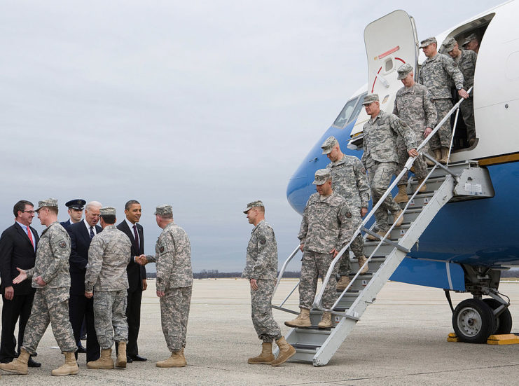 Barack Obama and Joe Biden shaking hands with US soldiers as they disembark from an aircraft