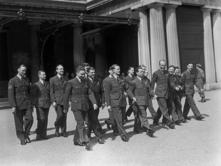 Guy Gibson walking with members of No. 617 Squadron RAF outside of Buckingham Palace