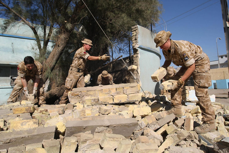 British soldiers moving around cement bricks