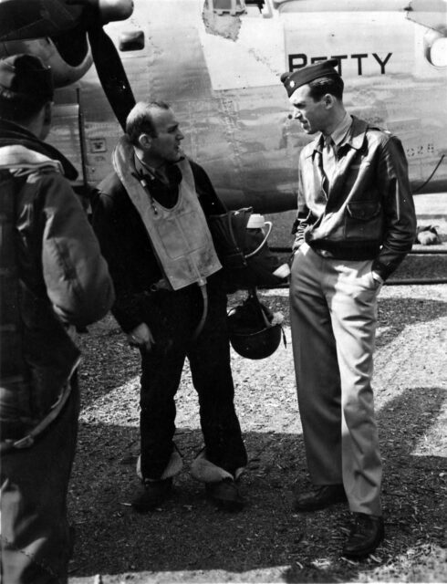 James Stewart standing with another airman in front of an aircraft