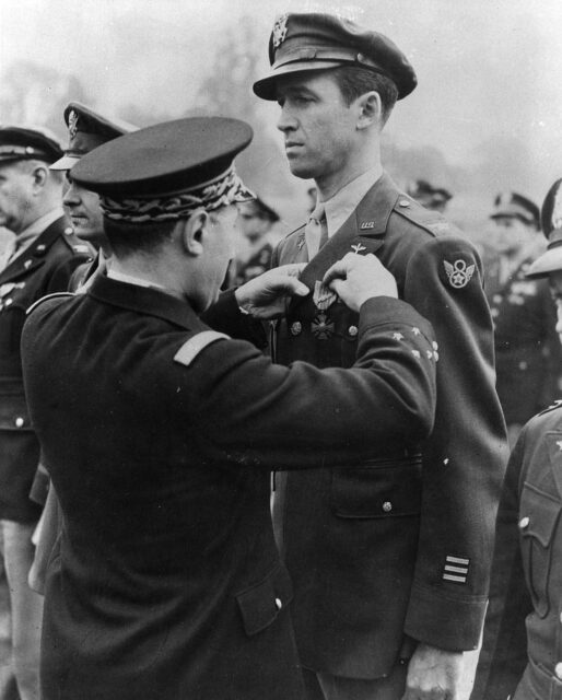 French military official pinning the Croix de Guerre with palm to James Stewart's uniform