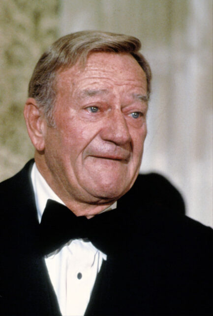 John Wayne dressed in a suit
