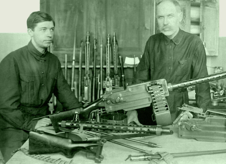 Fedor Tokarev and his son standing with a Maxim-Tokarev