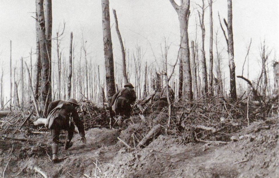 US Marines running through a combat-wrecked forest