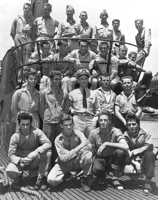 Crew of the USS Tang (SS-306) sitting together atop the submarine