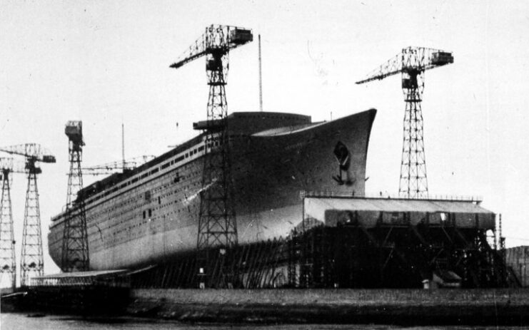 Cranes positioned around a partially-constructed SS Normandie