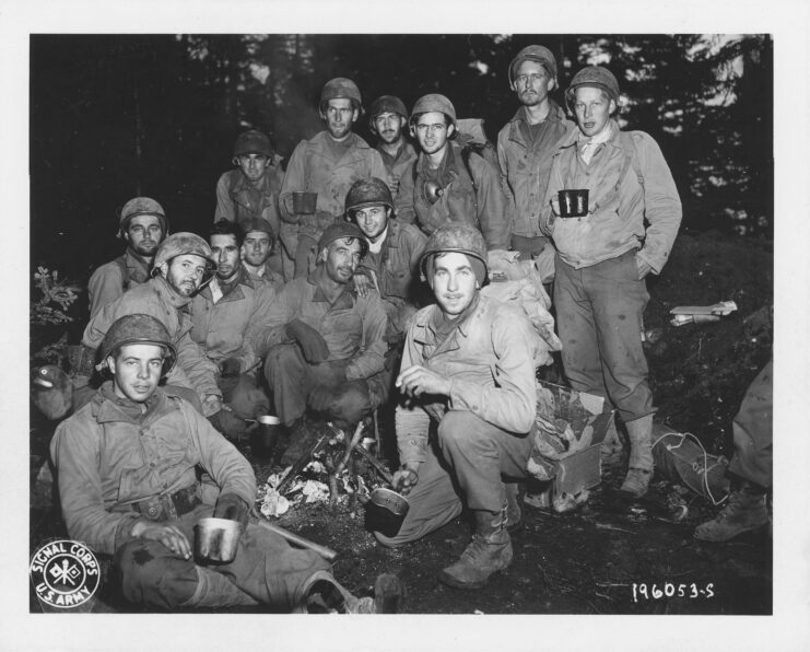 Members of the Texas Battalion standing together in a wooded area