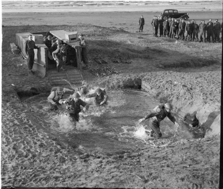 British Commandos jumping into a pond after disembarking from a landing craft