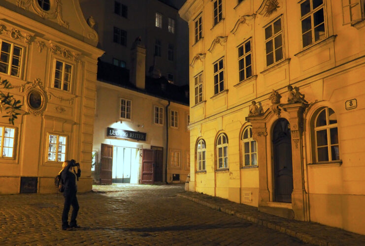 Woman taking a picture of a doorway at night