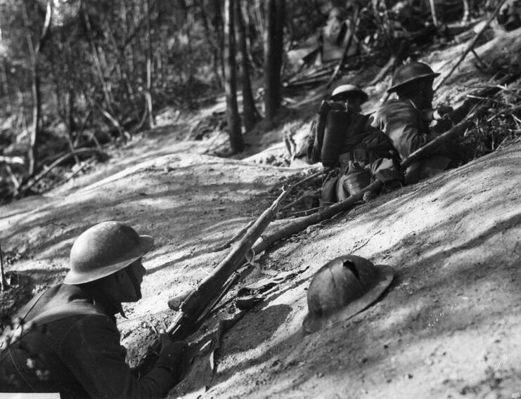 Members of the 18th Infantry Regiment, 1st Infantry Division scaling Hill 240