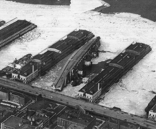 Aerial view of the USS Lafayette (AP-53) capsized at Pier 88