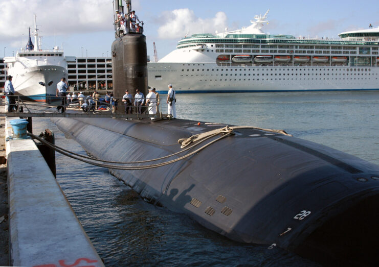 Sailors standing atop the USS Miami (SSN-755) while at port