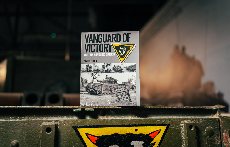 'Vanguard of Victory: The 79th Armoured Division' placed atop an armored vehicle
