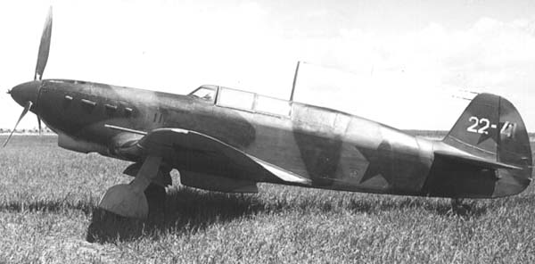 Yakovlev Yak-7B parked in a grassy field