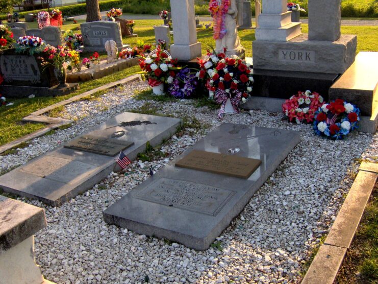 Two graves surrounded by stones and flowers