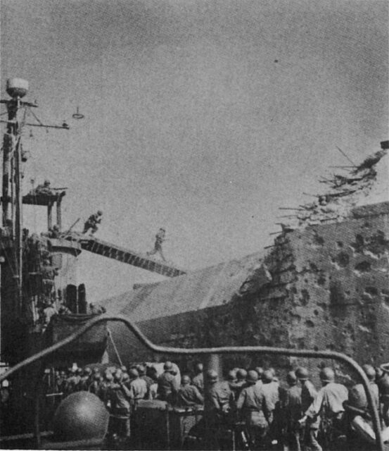 US landing party running across a bridge toward Fort Drum