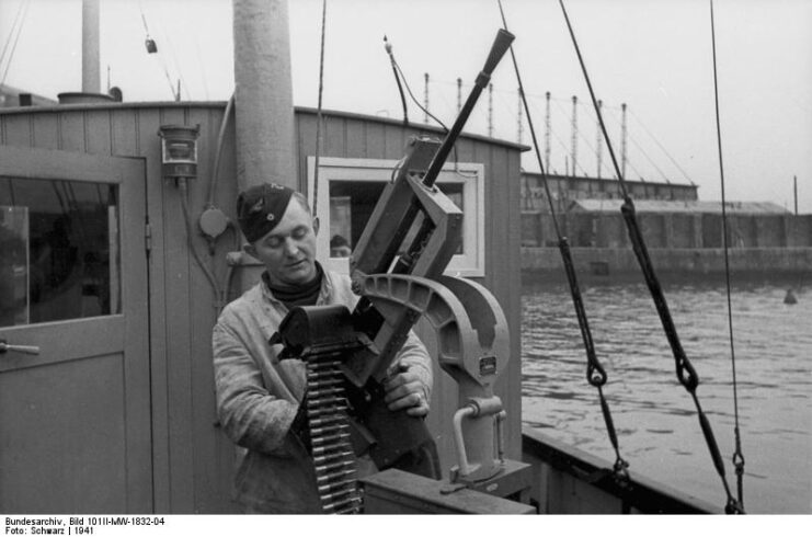 Soldier manning a Darne machine gun on a boat