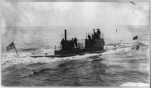 Crewmen standing on the deck of the Defender