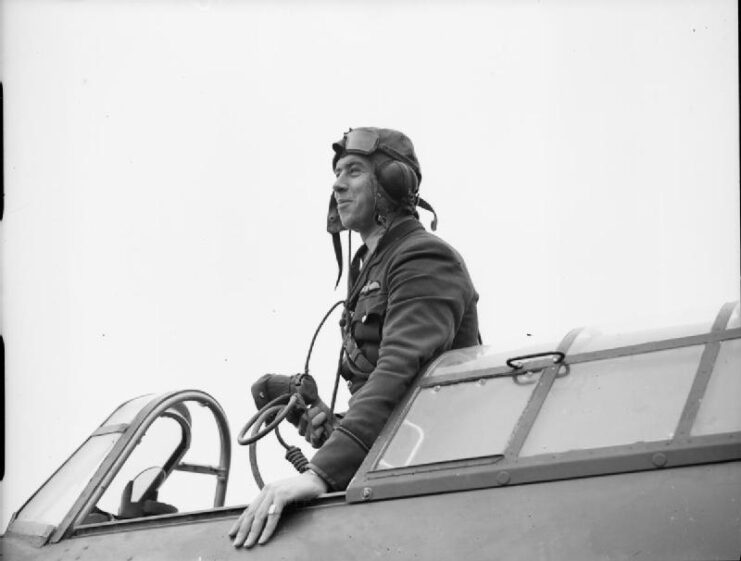 Edgar "Cobber" Kain standing in the cockpit of his Hawker Hurricane Mk I