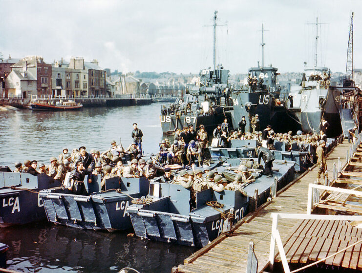 American troops sitting in docked landing craft