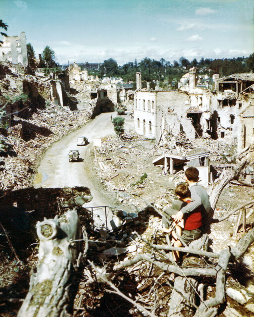 Two children looking out over the remnants of Saint-Lô