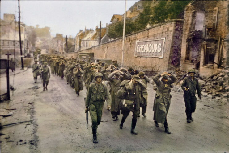 American troops leading German prisoners of war (POWs) down a street