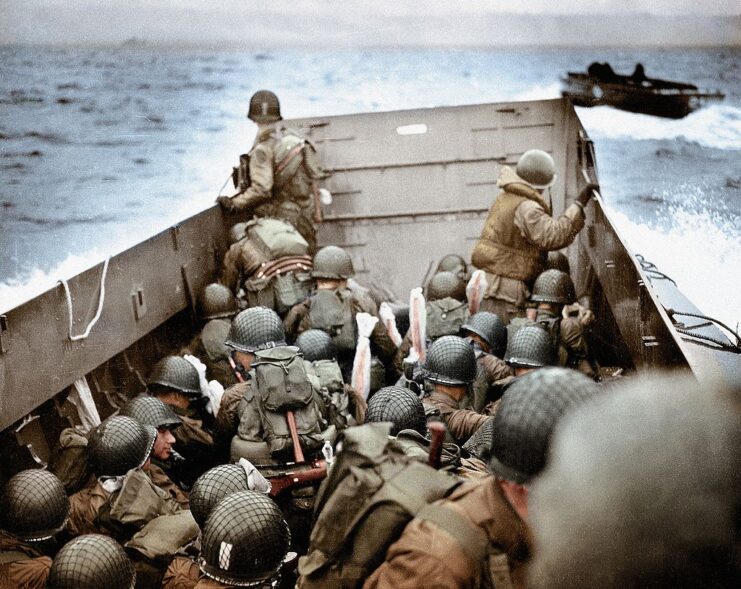 Members of Company E, 16th Infantry Regiment, 1st Infantry Division aboard a landing craft at sea