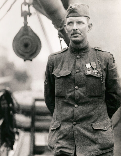 Sgt Alvin York standing in uniform, with his medals pinned to his chest