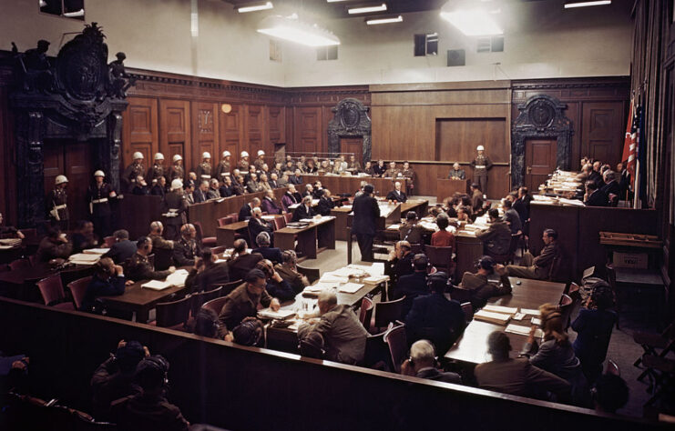 Military and law officials standing in a courtroom