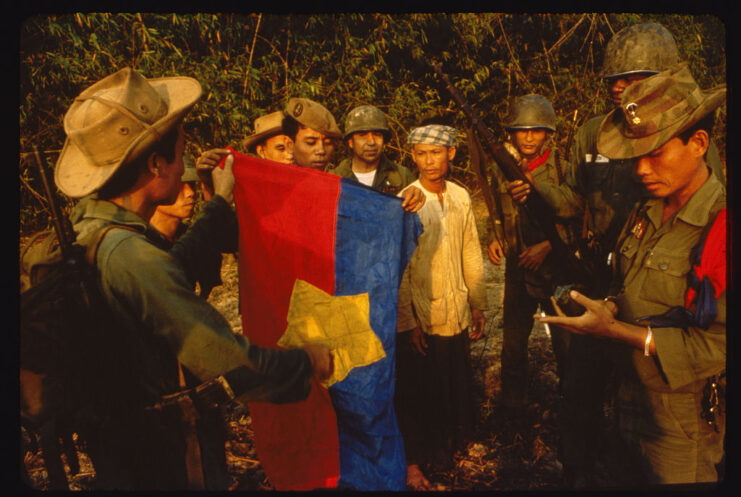 Members of a Phoenix Program reconnaissance team holding up a captured Viet Cong flag