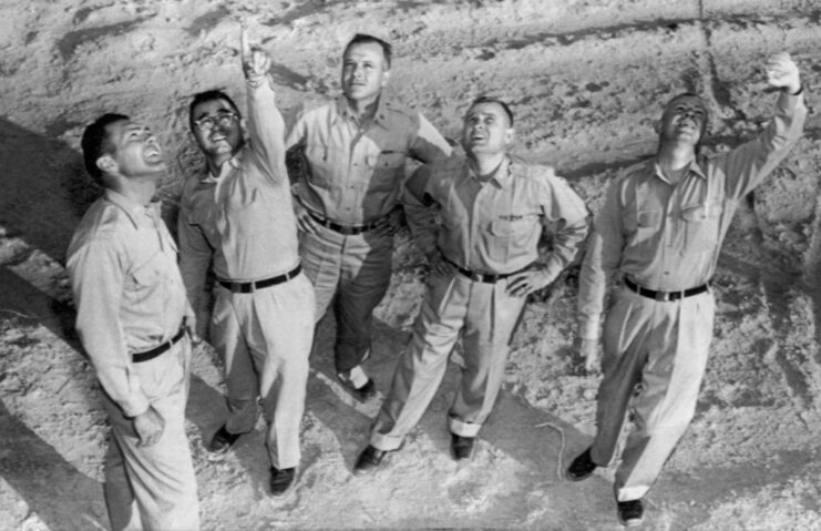 Five US Air Force airmen standing together outside