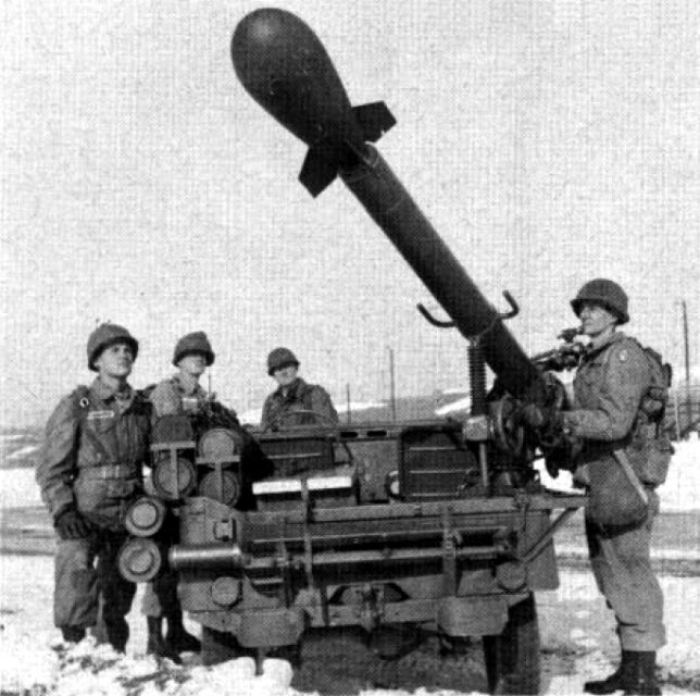 Four US soldiers standing around a Jeep-mounted M28/M29 Davy Crockett Weapon System