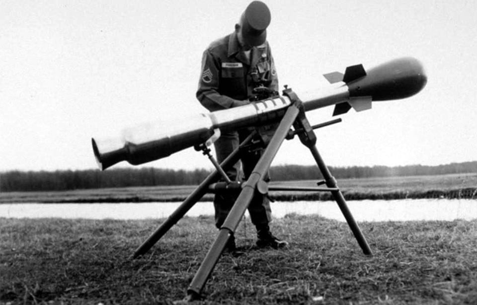 Soldier standing with an M28/M29 Davy Crockett Weapon System outside
