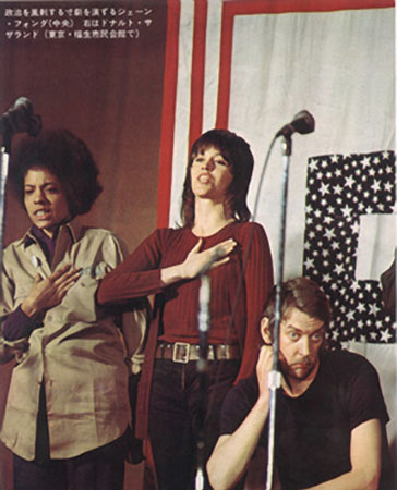 Rita Martenson, Jane Fonda and Donald Sutherland standing together on stage